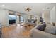Open living area with wood floors flows to kitchen and features sliding glass doors to patio at 18004 Avalon Ln, Tampa, FL 33647