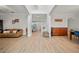 Spacious living area with light wood floors, neutral walls, and an open floor plan with staircase at 18004 Avalon Ln, Tampa, FL 33647
