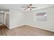 Bright bedroom with wood-look floors, ceiling fan, and a window with natural light at 1826 Cadillac Cir, Tampa, FL 33619