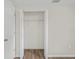 Open closet featuring hardwood floors and shelving for organization at 1826 Cadillac Cir, Tampa, FL 33619