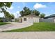 Charming single-story home with a well-maintained lawn and a covered carport at 1826 Cadillac Cir, Tampa, FL 33619