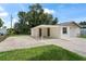 Charming home with a spacious driveway, lush lawn, and a covered carport area at 1826 Cadillac Cir, Tampa, FL 33619