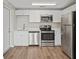 Modern kitchen with stainless steel appliances and sleek white cabinetry at 1826 Cadillac Cir, Tampa, FL 33619