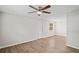 Spacious living room with updated floors, a ceiling fan, and a rear entry door at 1826 Cadillac Cir, Tampa, FL 33619