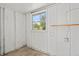 Image shows the utility room with white painted walls, a window, and electrical components at 1826 Cadillac Cir, Tampa, FL 33619