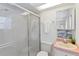 Bathroom featuring a shower with decorative glass, vanity with sink, and toilet at 18561 Winding Oaks Blvd, Hudson, FL 34667