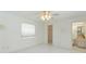 Clean bedroom with tile flooring, ceiling fan, closet, and ensuite bathroom, providing comfort and convenience at 18561 Winding Oaks Blvd, Hudson, FL 34667