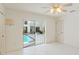 Bright bedroom with tile flooring and sliding glass doors overlooking the refreshing outdoor swimming pool area at 18561 Winding Oaks Blvd, Hudson, FL 34667