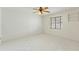 Minimalist bedroom with tile flooring, ceiling fan, and window with blinds, perfect for relaxation at 18561 Winding Oaks Blvd, Hudson, FL 34667