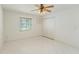 Bedroom with tile flooring, ceiling fan, closet, and window with blinds, offering a cozy retreat at 18561 Winding Oaks Blvd, Hudson, FL 34667
