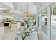 Eat-in kitchen with glass table, views of the fireplace, and an open concept layout; perfect for gatherings at 18561 Winding Oaks Blvd, Hudson, FL 34667