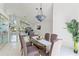Open dining room with high ceilings, decorative chandelier, and views into the living area at 18561 Winding Oaks Blvd, Hudson, FL 34667