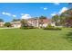 Charming single-Gathering home with a well-manicured lawn and an attached three-car garage at 18561 Winding Oaks Blvd, Hudson, FL 34667