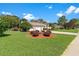 A single-Gathering home with well-maintained landscaping and a charming lamp post centerpiece at 18561 Winding Oaks Blvd, Hudson, FL 34667
