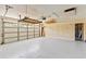 Spacious two car garage with finished floor and overhead storage racks at 18561 Winding Oaks Blvd, Hudson, FL 34667