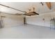 Large garage with white floor and overhead storage racks at 18561 Winding Oaks Blvd, Hudson, FL 34667
