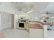 Efficient kitchen with white cabinets and tile floors at 18561 Winding Oaks Blvd, Hudson, FL 34667