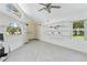 Bright living room with tile flooring, unique windows, and built-in shelving offers a spacious area at 18561 Winding Oaks Blvd, Hudson, FL 34667