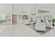 Open-concept living room boasts tile floors, a wet bar, and views of the pool at 18561 Winding Oaks Blvd, Hudson, FL 34667