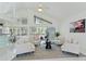 Bright living room features high ceilings, tile floors, and sliding doors to a screened patio at 18561 Winding Oaks Blvd, Hudson, FL 34667