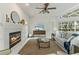 Inviting living room features a fireplace, a ceiling fan, and views of the pool, perfect for relaxing at 18561 Winding Oaks Blvd, Hudson, FL 34667