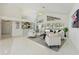 Bright living room features high ceilings, tile floors, and sliding doors to the lanai at 18561 Winding Oaks Blvd, Hudson, FL 34667