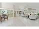 Spacious living room with bar, tile flooring, and lots of natural light at 18561 Winding Oaks Blvd, Hudson, FL 34667