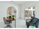 Well-lit office with white walls, arched doorway, and sliding glass doors to outdoor pool area at 18561 Winding Oaks Blvd, Hudson, FL 34667