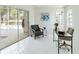 Bright office space featuring white tile floors, pool view through sliding doors, and modern decor at 18561 Winding Oaks Blvd, Hudson, FL 34667