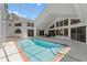 Indoor pool area featuring a large pool, hot tub, and plenty of lounging space at 18561 Winding Oaks Blvd, Hudson, FL 34667