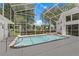 Enclosed swimming pool with clear water, patio surround, and jacuzzi at 18561 Winding Oaks Blvd, Hudson, FL 34667