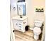 Updated bathroom with a new vanity, black fixtures, toilet, and modern decor at 1884 Clearbrooke Dr, Clearwater, FL 33760