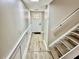 Entryway with light wood floors and staircase, blending style and practicality for a welcoming home entrance at 1884 Clearbrooke Dr, Clearwater, FL 33760