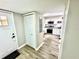 Inviting entryway with a coat closet, leading into a stylish kitchen featuring stainless steel appliances and granite counters at 1884 Clearbrooke Dr, Clearwater, FL 33760