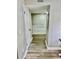 Hallway with wood floors offering seamless transition between spaces with neutral paint and white door at 1884 Clearbrooke Dr, Clearwater, FL 33760