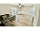 Spacious living area with wood flooring, a ceiling fan, and sliding glass doors to the outside at 1884 Clearbrooke Dr, Clearwater, FL 33760