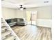 Comfortable living room with a sectional sofa, sliding glass doors to the backyard, and wood-look vinyl flooring at 1884 Clearbrooke Dr, Clearwater, FL 33760