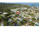 Aerial view of a neighborhood highlighting the location of the house with mature trees and proximity to the water at 2005 Jefferson Ave, Dunedin, FL 34698