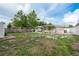 Large backyard with lush greenery, a shed, and patio at 2005 Jefferson Ave, Dunedin, FL 34698