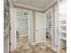Hallway featuring tile floors and doorways leading to multiple bedrooms and a closet at 2005 Jefferson Ave, Dunedin, FL 34698