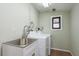 Laundry room featuring a new washer and dryer and an utility sink at 2005 Jefferson Ave, Dunedin, FL 34698
