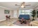 Cozy seating area in a living room, with bright windows and an exterior door at 2005 Jefferson Ave, Dunedin, FL 34698