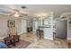 Inviting open-concept living space with tile floors, a ceiling fan, and a view into the kitchen at 2005 Jefferson Ave, Dunedin, FL 34698