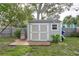 Exterior view of the shed and a small wooden porch at 2005 Jefferson Ave, Dunedin, FL 34698