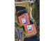 An aerial view shows the layout of the condo complex with parking, a pond and the roof top deck at 244 & 243 Mariner Dr # 243-244, Tarpon Springs, FL 34689