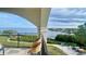 Breathtaking water view from a private balcony with seating overlooking manicured lawns and shoreline at 244 & 243 Mariner Dr # 243-244, Tarpon Springs, FL 34689