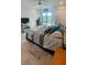A cozy bedroom with sliding glass doors to a balcony, featuring a ceiling fan and comfortable furnishings at 244 & 243 Mariner Dr # 243-244, Tarpon Springs, FL 34689