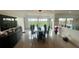Bright dining room with elegant black dining set and scenic views through large windows at 244 & 243 Mariner Dr # 243-244, Tarpon Springs, FL 34689