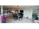 Spacious dining room with modern lighting, marble table set, and open transition to kitchen at 244 & 243 Mariner Dr # 243-244, Tarpon Springs, FL 34689