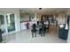 Open-concept dining area featuring a sleek marble table set and seamless flow into the kitchen at 244 & 243 Mariner Dr # 243-244, Tarpon Springs, FL 34689